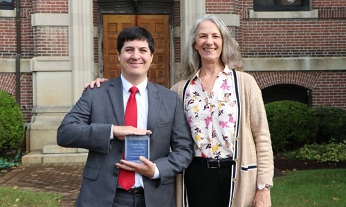 Associate Professor of Justice and Law Administration Thomas A. Miller accepts the Provost's Award from Provost and Vice President of Academic Affairs Dr. Missy Alexander.
