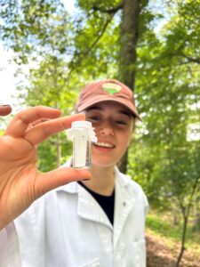 Student research assistant Alyza Weisman holds a vial with field-collected ticks.
